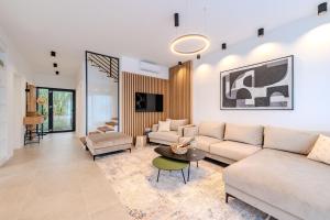 a living room with a couch and a table at Beachfront Villa Jugo with Seaview in Privlaka