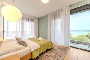 a bedroom with a bed and a large window at Beachfront Villa Jugo with Seaview in Privlaka +37 photos