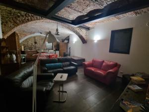 a living room with a couch and a table at Guest House Seme Di Faggio in Miasino