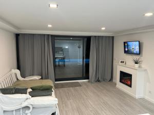 a living room with a couch and a fireplace at Coura Lodge in Paredes de Coura