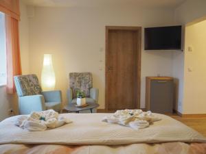 a hotel room with a bed with towels on it at Peaceful Couples' Getaway in Breitenbrunn