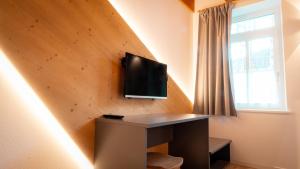TV a/nebo společenská místnost v ubytování Appartamento Vale e Schena Cortina D'Ampezzo
