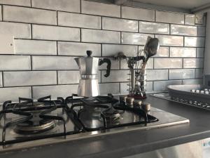 a kitchen stove top with a tea kettle on it at Affordable Luxury 1 Stunning apartment Sunderland close to City centre hospital Crown Works Studio and Nissan in Sunderland +22 photos