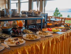 a buffet with plates of food on a table at Patagonia Hotel in San Carlos de Bariloche