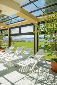 a row of white chairs sitting on a patio at Patagonia Hotel in San Carlos de Bariloche