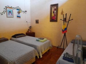 a bedroom with two beds and a picture on the wall at El Patio de la Morocha in Montevideo