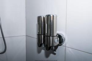 a towel dispenser on a wall in a bathroom at The Fine Line Lodge in Pretoria