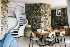 a dining room with a table and a staircase at BLUVARI' Charming House in Alassio