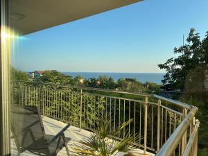 a balcony with a chair and a view of the ocean at Villa Black Sea in Balchik