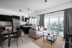 a kitchen and living room with a couch and a table at Armonia 17 suites by Yellowkey in Santo Domingo