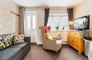a living room with a couch and a television at Private Flat in Warwickshire in Warwick