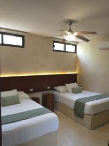 Una cama o camas en una habitación de Cssa Kareli Holbox