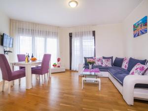 a living room with a couch and a table at Bel&Rus Sea Apartment in Budva