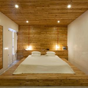 a large bed in a room with wooden walls at The Literary Man Obidos Hotel in Óbidos +77 photos