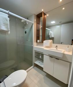 ein Badezimmer mit Dusche, Toilette und Waschbecken in der Unterkunft Flat no Nannai Residence - Muro Alto in Porto De Galinhas