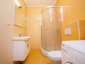 a bathroom with a shower and a toilet and a sink at Bel&Rus Sea Apartment in Budva +27 photos