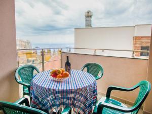 una mesa con una botella de vino y un bol de fruta en Bel&Rus Sea Apartment, en Budva