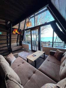 a living room with a couch and a table at Ediz Suit Bungalov in Ardeşen +8 photos