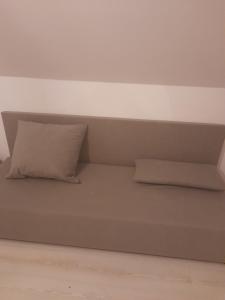 a bed in a room with two pillows on it at Hotel Kaukaz in Kraków