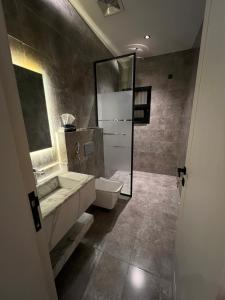 a bathroom with a toilet and a sink and a shower at Luxury Three Bedroom Apartment with Trans in Riyadh +19 photos