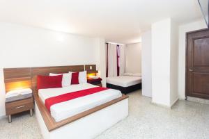 Postel nebo postele na pokoji v ubytování Hotel Bicentenario Rionegro