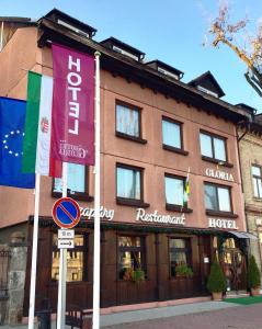 a building with two flags in front of it at Hotel Gloria Budapest City Center in Budapest