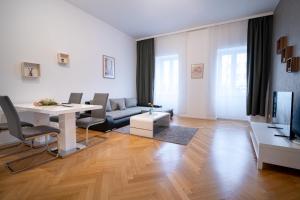 a living room with a table and a couch at Home Sweet Home - Leopold in Vienna