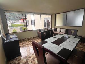 a dining room with a table and a couch at Apartamento recien estrenado in Baños