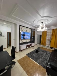 a living room with a large flat screen tv at Dortmund Appartment in Douala