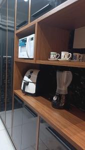 Kuchyň nebo kuchyňský kout v ubytování Apto com ar, lazer, conforto e portaria 24h ideal para famílias!