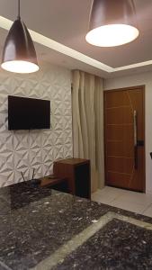 TV a/nebo společenská místnost v ubytování Apto com ar, lazer, conforto e portaria 24h ideal para famílias!