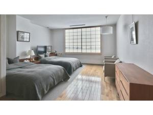 a bedroom with two beds and a window in it at Ryokan Akebono - Vacation STAY 97660v in Saga