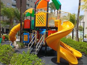 a playground with a slide in a park at Salinas Premium Resort in Salinópolis