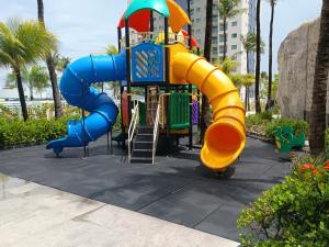 a blue and yellow slide at a playground at Salinas Premium Resort in Salinópolis