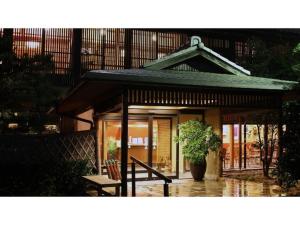 a small house with a potted plant in the rain at Ryokan Akebono - Vacation STAY 97632v in Saga