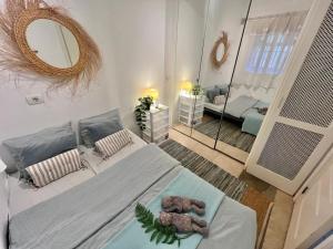 a bedroom with a bed with a teddy bear on it at Sunny terrace & pool in Playa de las Americas