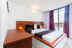 Postel nebo postele na pokoji v ubytování Hotel Bicentenario Rionegro