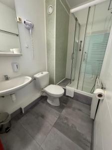 a bathroom with a toilet and a sink and a shower at Hotel Gloria Budapest City Center in Budapest