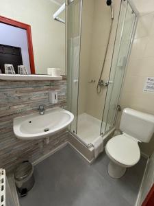 a bathroom with a sink and a toilet and a shower at Hotel Gloria Budapest City Center in Budapest