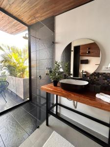 a bathroom with a black tub and a mirror at Hotel Boutique el Fique in Los Santos +37 photos
