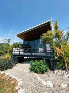 a house on a beach with palm trees at Hotel Boutique el Fique in Los Santos