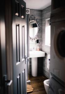 a bathroom with a sink and a mirror at Coalminer's Cottage in Gateshead +20 photos