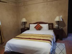 Postel nebo postele na pokoji v ubytování Kasbah Zitoune
