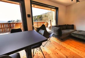 a living room with a table and chairs and a couch at Alpine Retreat house Šurc in Rateče