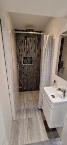 a bathroom with a shower and a toilet and a sink at Beautiful cozy studio in Hounslow +16 photos