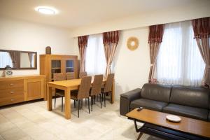 a living room with a couch and a dining room table at Cozy family home near LottoArena Antwerpen in Antwerp