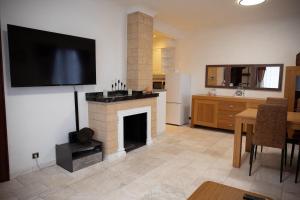 a living room with a fireplace and a flat screen tv at Cozy family home near LottoArena Antwerpen in Antwerp