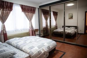 a bedroom with two beds and a mirror at Cozy family home near LottoArena Antwerpen in Antwerp