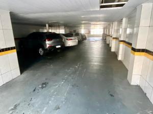 a parking garage with cars parked in it at Hotel Atlanta - Salvador - BA in Salvador