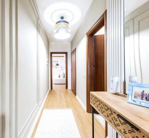 a hallway with a console table and a bathroom at Central Premium Residence Beachfront in Durrës